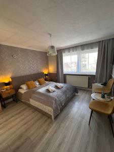 sypialnia z dużym łóżkiem i biurkiem w obiekcie Jager Guesthouse w mieście Sopron
