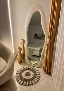 a living room with a white mirror and a rug at Villa Searra - Ocean Breeze Boutique Hotel Hideaway Rooms in Canggu