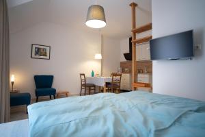 a bedroom with a bed and a dining room at Ferienwohnungen Maijeschhof in Pelm