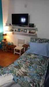 a bedroom with a bed and a flat screen tv at Vale de Garcia AL 5357 in Colos