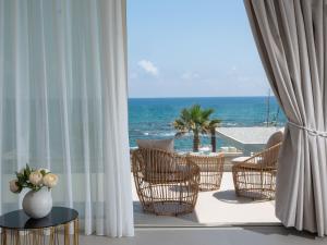 a balcony with chairs and a view of the ocean at Hersonissos Beach Villa in Hersonissos