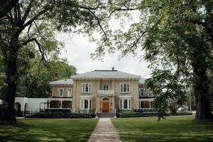 an exterior view of a mansion with trees at The CAPE in Picton