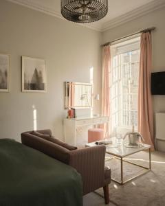 a living room with a couch and a table at The Queensberry Hotel in Bath