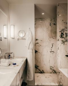 a bathroom with a sink and a shower at Hôtel Les Roches Blanches Cassis in Cassis +37 photos