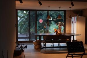 a dining room with a table and a large window at Yangshuo Hillside Homestay in Yangshuo