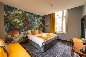 a hotel room with a bed and a mural at The Market House in Reading