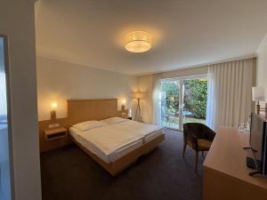 a hotel room with a bed and a window at Hotel Restaurant Brinckwirth in Ochtrup +42 photos
