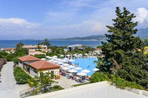 an overview of a resort with a pool and umbrellas at Spiros House in Roda