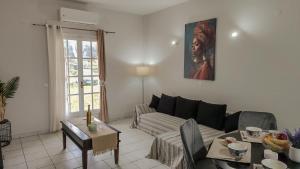a living room with a couch and a table at Spiros House in Roda