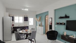 a kitchen and dining room with a table and chairs at Spiros House in Roda
