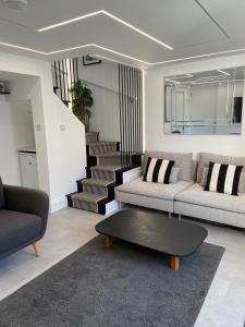 a living room with a couch and a coffee table at The Motor House in Worthing
