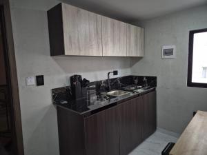 a kitchen with a sink and a counter top at Laureles del parque Loft in Barranquilla