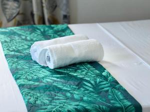 two rolled towels sitting on top of a bed at Villa Océan Gravier Rodrigues in Mt Bois Noir +57 photos
