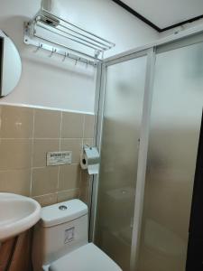 a bathroom with a shower and a toilet and a sink at Cozy Bella in Jalajala +18 photos