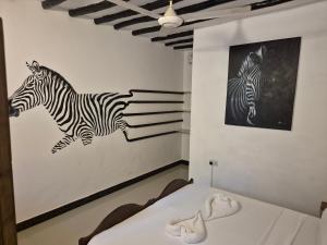 Postel nebo postele na pokoji v ubytování Ellavita Cottages Nungwi