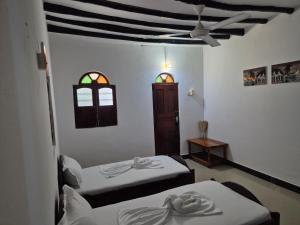 Postel nebo postele na pokoji v ubytování Ellavita Cottages Nungwi