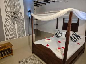 Postel nebo postele na pokoji v ubytování Ellavita Cottages Nungwi