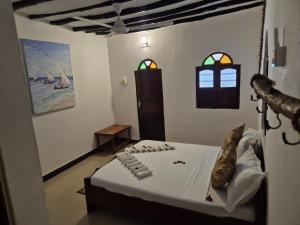 Postel nebo postele na pokoji v ubytování Ellavita Cottages Nungwi