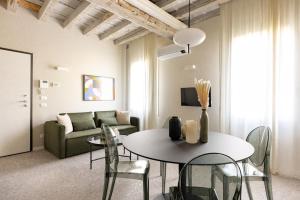 a living room with a table and a couch at Luxury Home in Vicenza in Vicenza