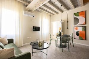 a living room with a table and chairs at Luxury Home in Vicenza in Vicenza