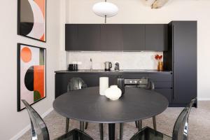 a kitchen with a table and chairs in a room at Luxury Home in Vicenza in Vicenza
