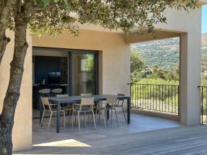 a table and chairs on a deck with a view at Domaine Villas Celia in Monticello