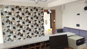 a living room with a wall of wine bottles at HOTEL SHREE JMM inn near by ion digital zone & pacific college in Debāri