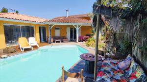 a swimming pool in front of a house at La chambre Soleil in Gujan-Mestras +6 photos