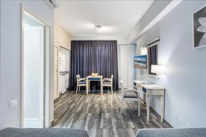 a room with a table and chairs and a kitchen at Apartamentos Colón Playa in Las Palmas de Gran Canaria +44 photos