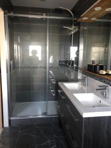 a bathroom with two sinks and a shower at Sub zéro in Saint-Jean-de-Tholome +18 photos