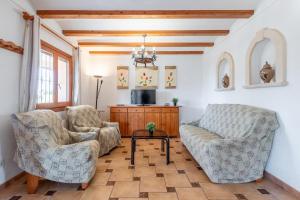 a living room with two chairs and a table at Merced in Calpe
