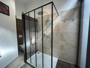 a shower with a glass door in a bathroom at Le Panier - Joli duplex Centre ville historique avec grande terrasse et balnéo proche Vieux Port in Marseille