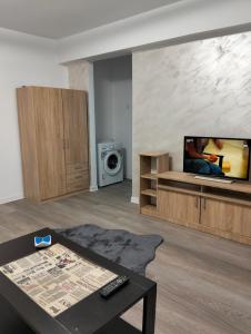 a living room with a flat screen tv on a wall at Apartament BIS in Buzau