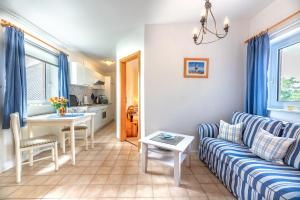 a living room with a couch and a table at Ferienhof Bruhn "Nr 3" in Midlum