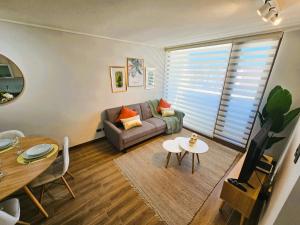 a living room with a couch and a table at 2D con estacionamiento Fantastico Depto - D'Home in Concepción