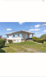 a large white house with a large yard at Maison Pierre 3 bedroom house with swimming pool in Léon