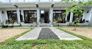 a building with a walkway in front of it at Surfing Pinthaliya - Midigama in Weligama