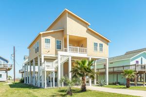 a large house with a balcony and palm trees at Amazing 360 Ocean & Bay Water Views in Freeport