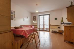 a kitchen with a table with a red and white table cloth at Due gnomi in Temù +17 photos