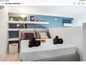a bedroom with a bed with pillows on it at Duomo In 8 Stop in Milan