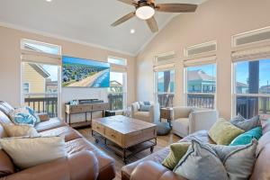 a living room with a couch and a table at Nauti By Nature home in Crystal Beach