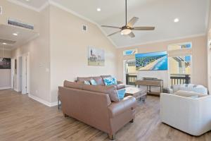 a living room with a couch and a ceiling fan at Nauti By Nature home in Crystal Beach