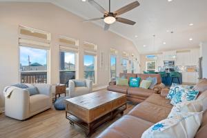 a living room with a couch and a table at Nauti By Nature home in Crystal Beach