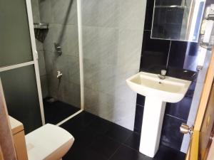 a small bathroom with a sink and a toilet at Green View Ella in Ella +61 photos