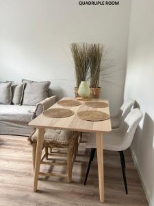 a wooden table and chairs in a living room at El Sol Zandvoort in Zandvoort +19 photos