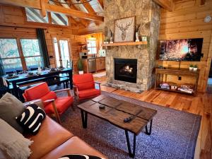 a living room with a couch and a fireplace at Mountain Hideaway - Hot Tub, Fire Pit, Close to Town in Ellijay