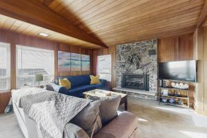a living room with a couch and a fireplace at The Lucky Starfish in Lincoln City