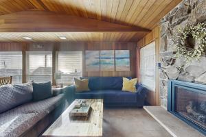 a living room with a blue couch and a fireplace at The Lucky Starfish in Lincoln City