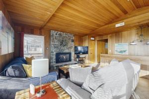 a living room with a couch and a tv at The Lucky Starfish in Lincoln City