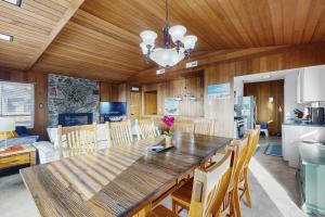 a kitchen and dining room with a large wooden table at The Lucky Starfish in Lincoln City +26 photos